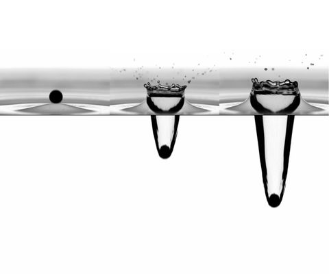 Graphical abstract: Water entry of small hydrophobic spheres on an axisymmetric wavefield